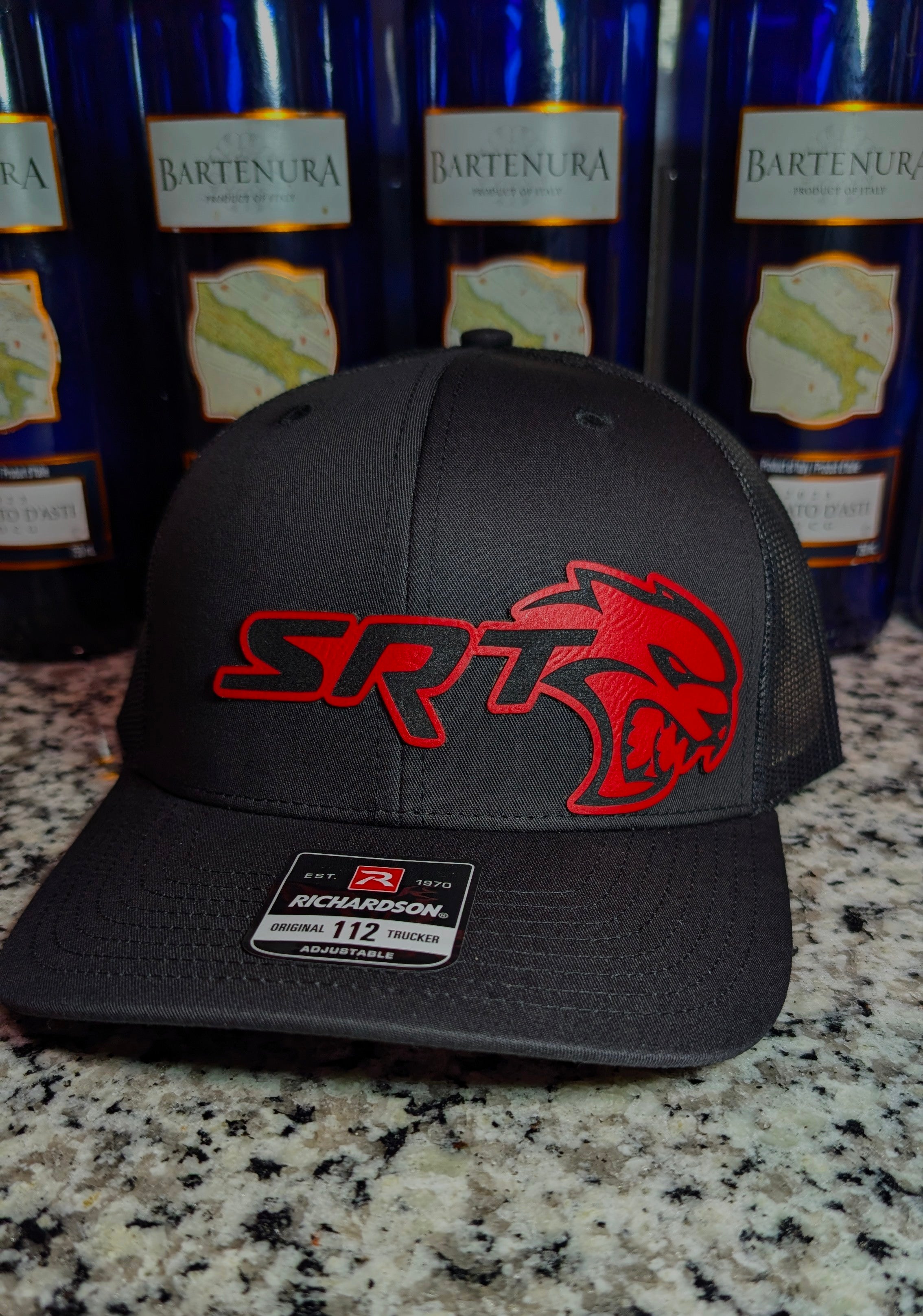 Hellcat Inspired Laser Engraved Richardson 112 Hat with Silver Carbon Fiber, Red Leather, and Gold Leather Accents." That should give all the details you need!