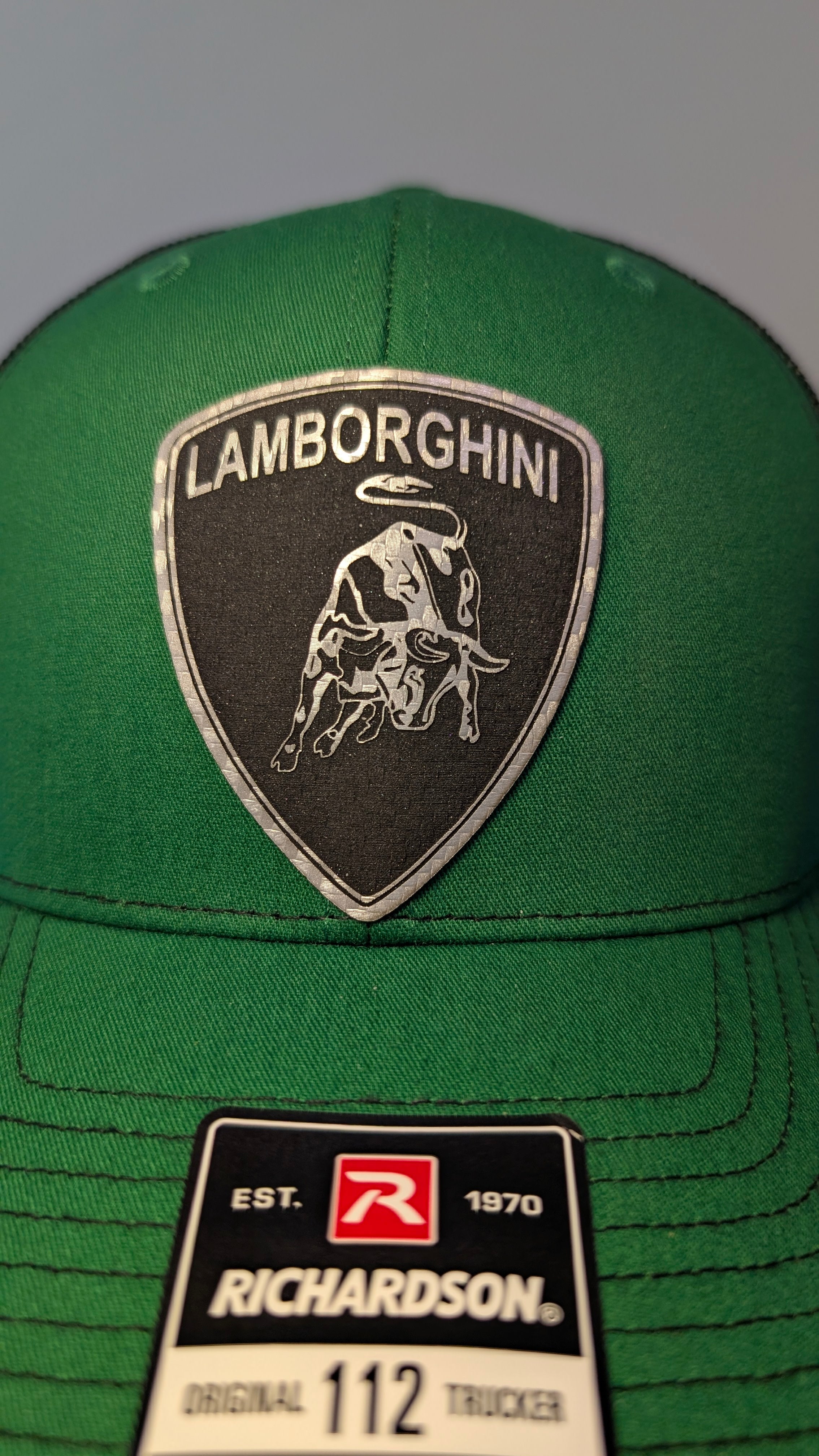 Handmade laser engraved silver carbon fiber leather patch hat inspired by the aggressive style of Italian supercars.